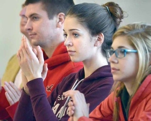 Students applaud at the announcement yesterday of the School Within a University partnership