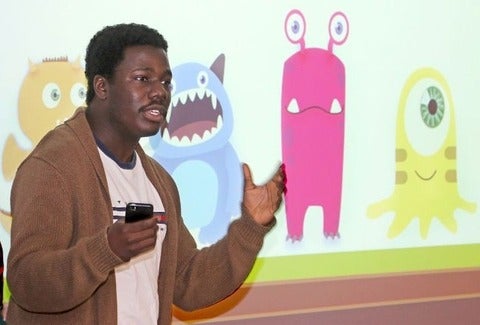 GBDA student Seyitan Oke presents his team's LaMonsters Club game concept at the University of Waterloo Stratford campus.