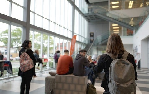 Students sitting in the Atrium of the Stratford School