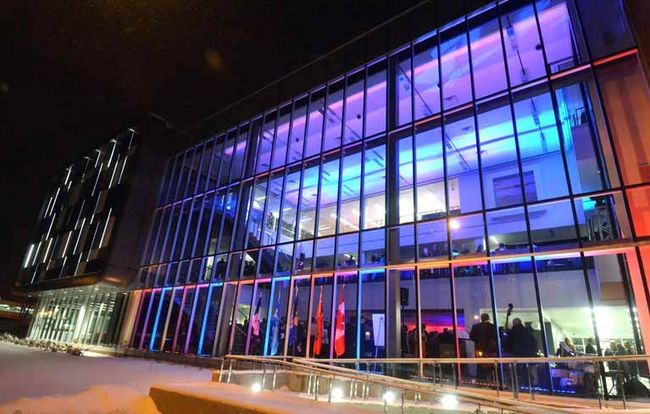Nighttime photo of the exterior of the Stratford Campus building.