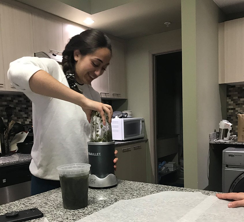 Virtuous Waste team member Amirah Mohamed works in the kitchen on a prototype with seaweed.
