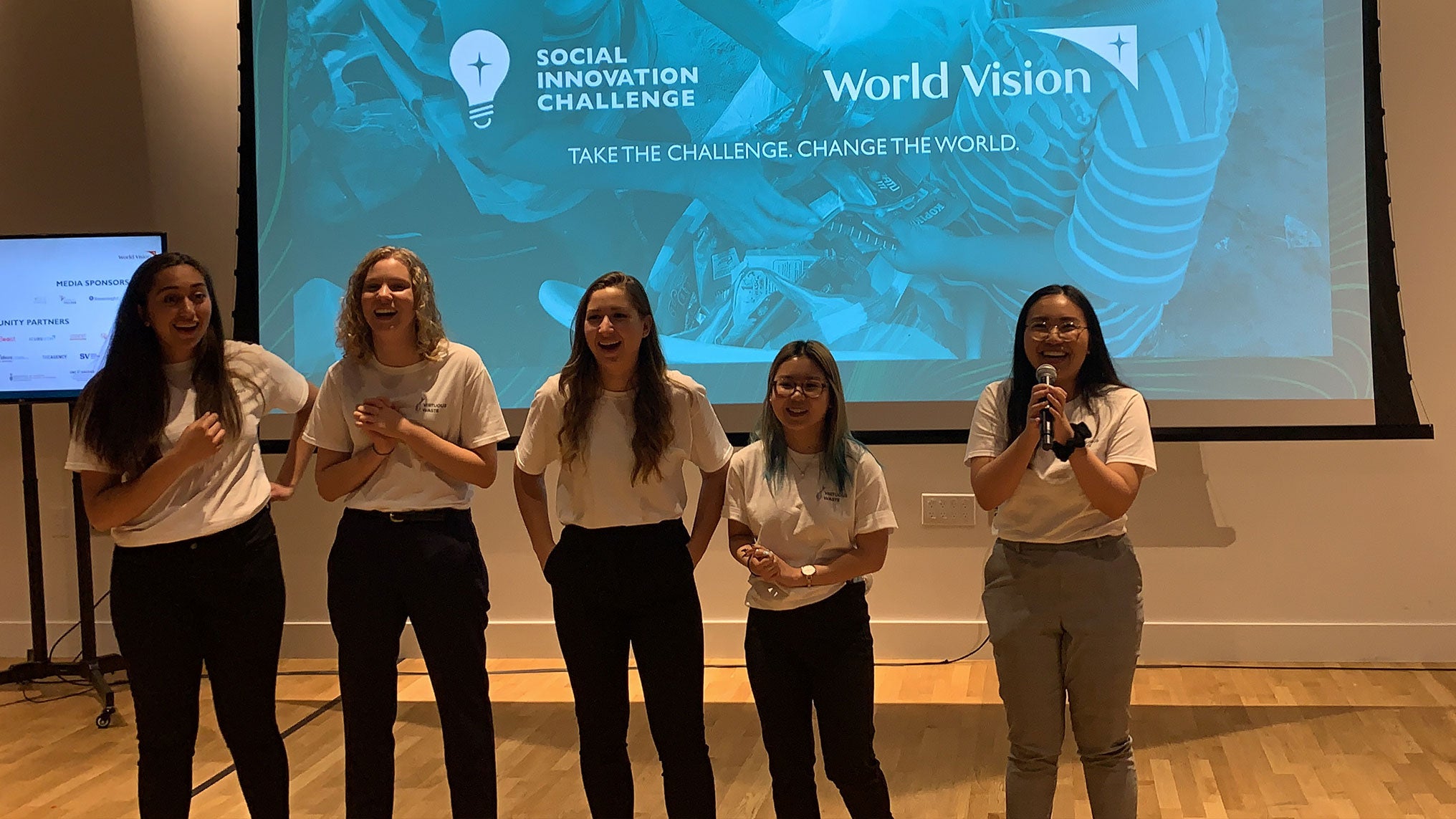 Virtuous Waste team smiling and laughing as the winners of the World Vison Social Innovation Challenge are announced.