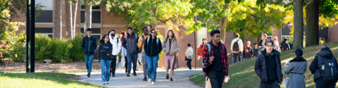 Students walking through campus on a beautiful fall day.