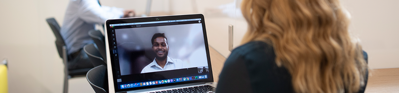 A student appears on screen during a video call