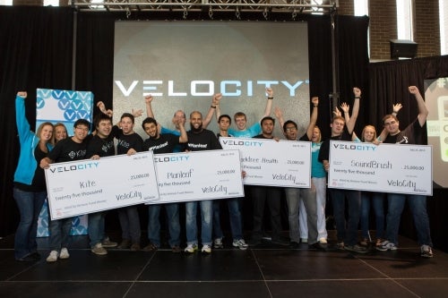 VeloCity Venture Fund winners holding giant cheques.