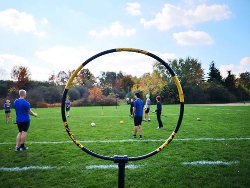 Photo of one hoop and quidditch players practicing.