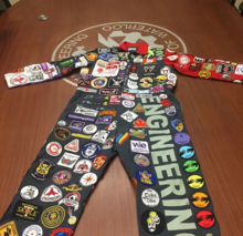 Engineering coveralls with patches from different Canadian universities.