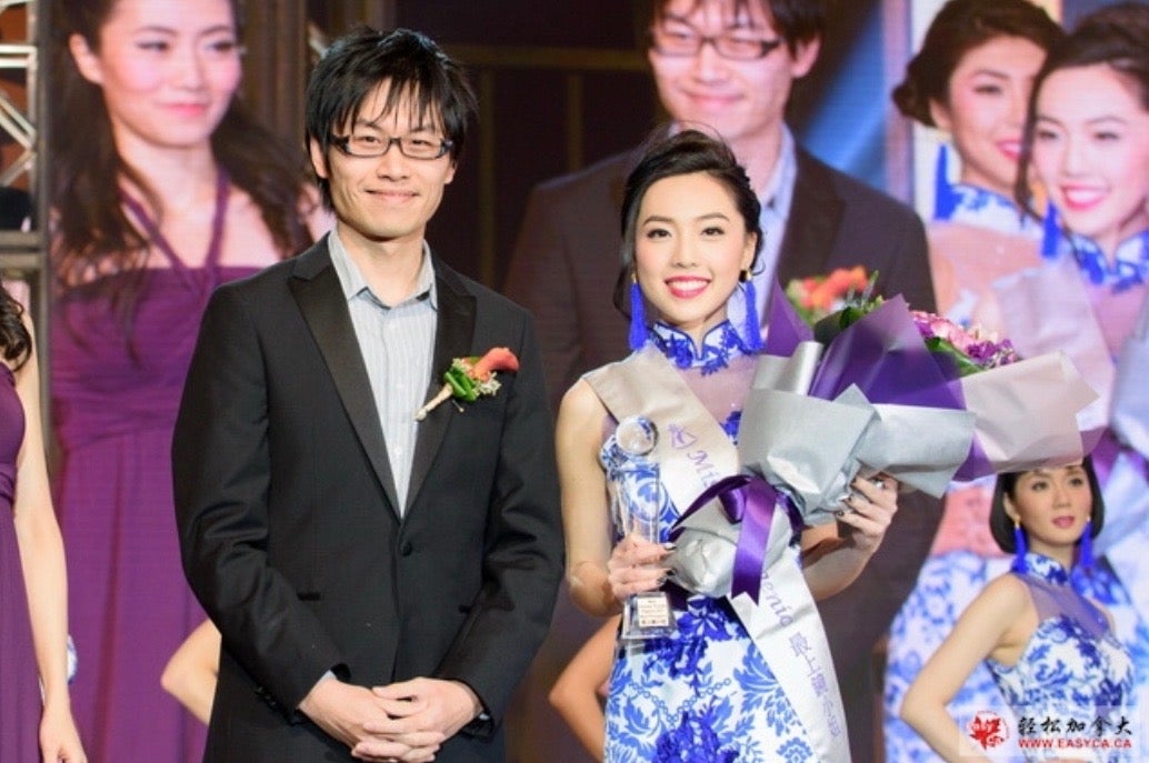 Selina standing beside the President of Kingscross Hyundai as she gets awarded Miss Photogenic