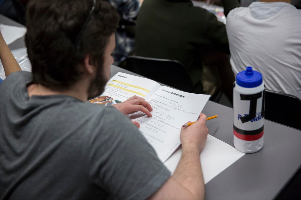 A student writing a test in a lecture hall
