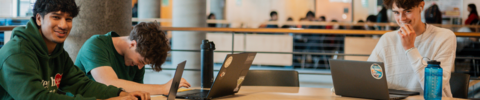 three students studying together in the upper level of the Student Life Centre.