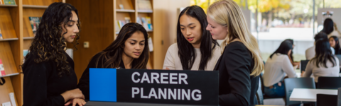 students huddled around a sign that reads 'career planning' in the Tatham Centre