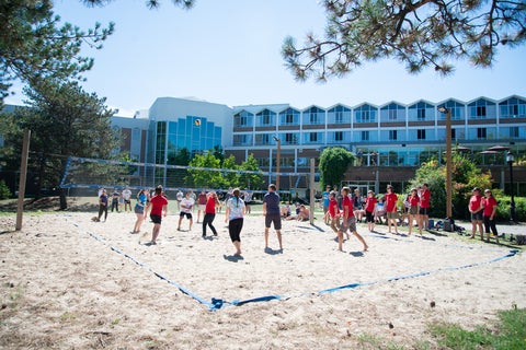 Outside shot of Conrad Grebel showcasing the beach volleyball court.
