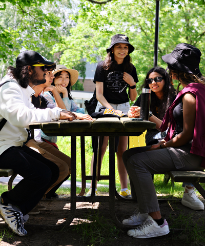A group of students gathered around a picnic table