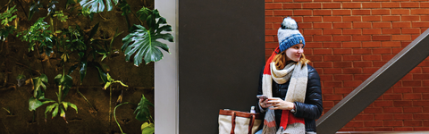 person looking at the distance, sitting on a ledge