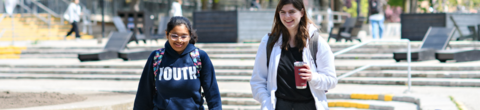 two students walking together through the Arts Quad