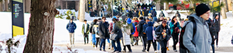 students walking on campus between classes in the winter