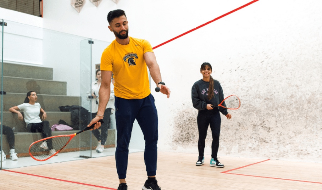 Two students playing racquetball at the PAC