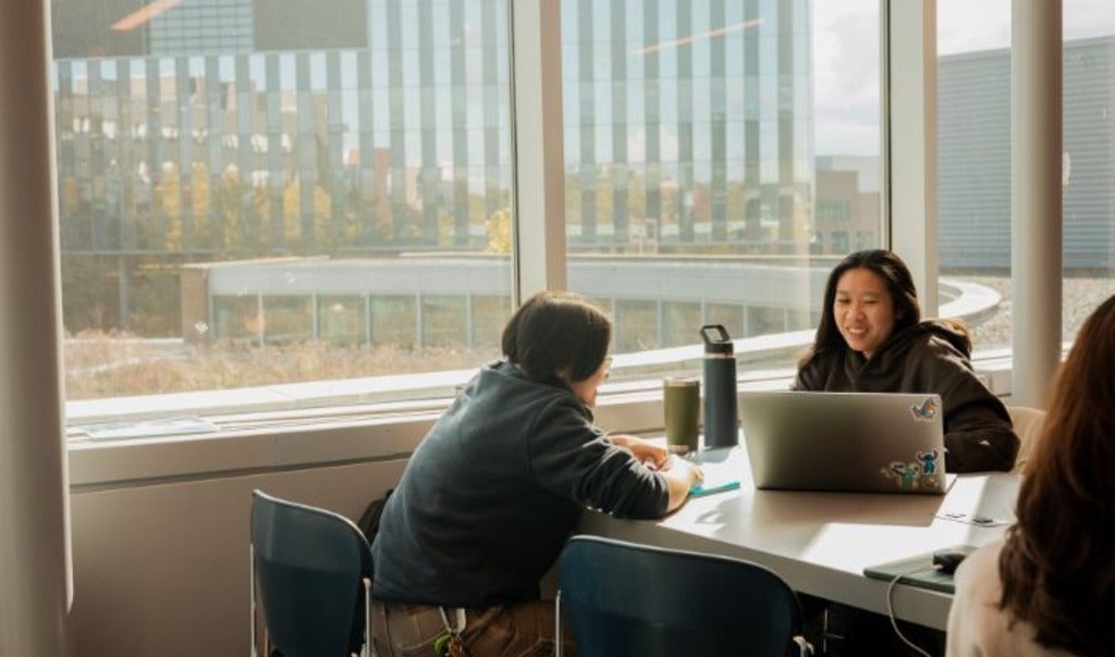 Two students sitting and talking