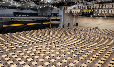 Rows of desks set up in the PAC for exams