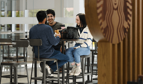 students sitting at a table in the EXP Starbucks