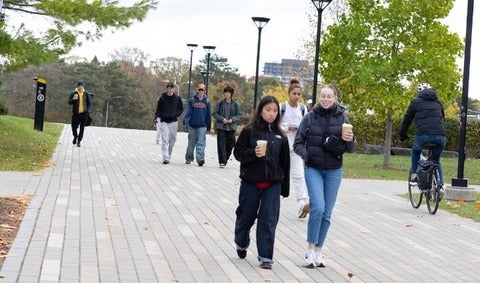 Students walking and talking on Two Row path