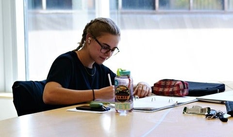 Student taking notes in a notebook