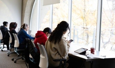 Students sitting and studying near the window in Dana Porter