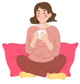 A girl sitting around pillows with her legs crossed and enjoying a cup of tea.
