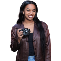 girl holding a camera and smiling