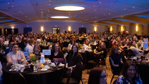 Attendees sitting at tables for the Women of the Year awards.