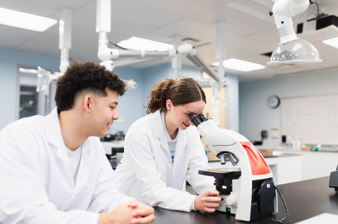students in the lab looking through a microscope