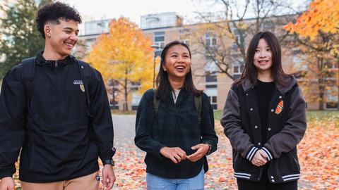 Students chat while walking on campus