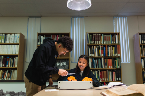 students in the library looking through archives