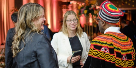 group of three people having a discussion