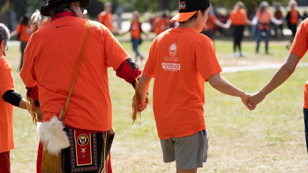 UWaterloo community members join a circle dance on Orange Shirt Day