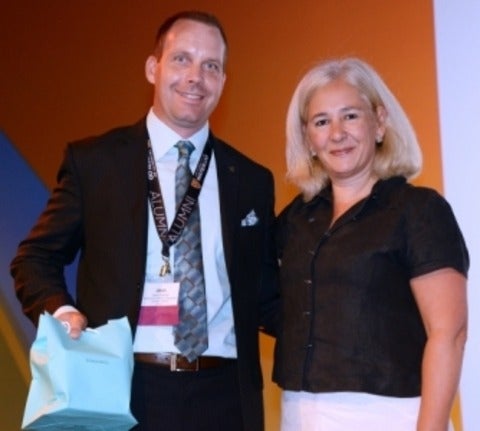 Jason Coolman accepts his award from CASE president Sue Cunningham