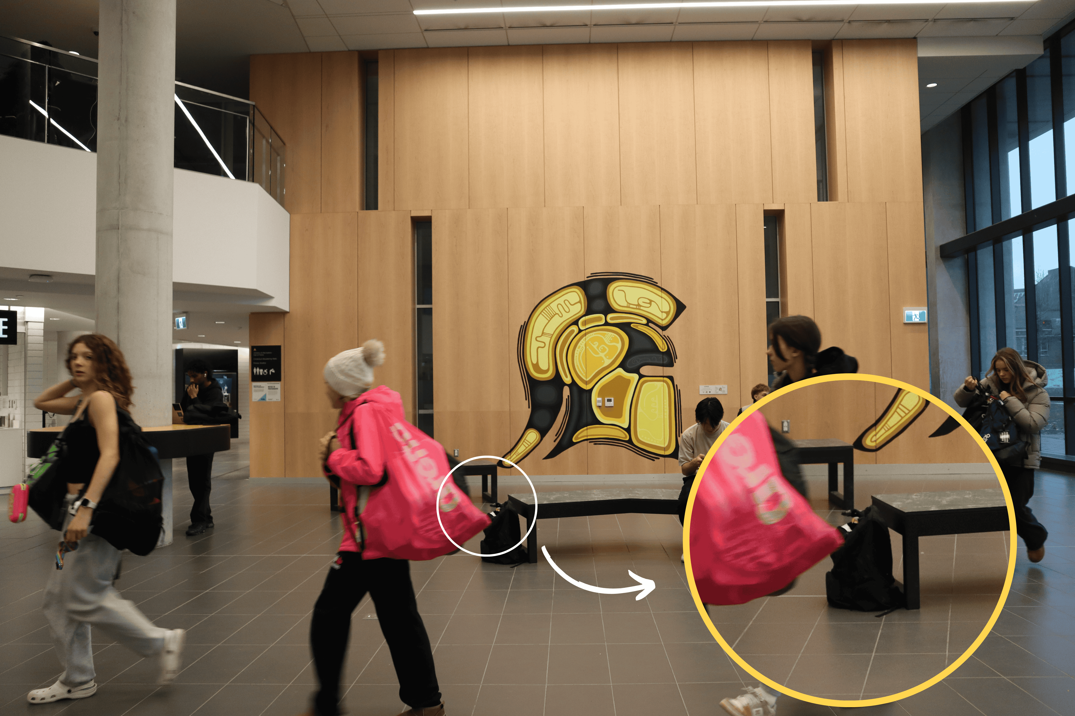 The goose is inside the black backpack placed beside the bench