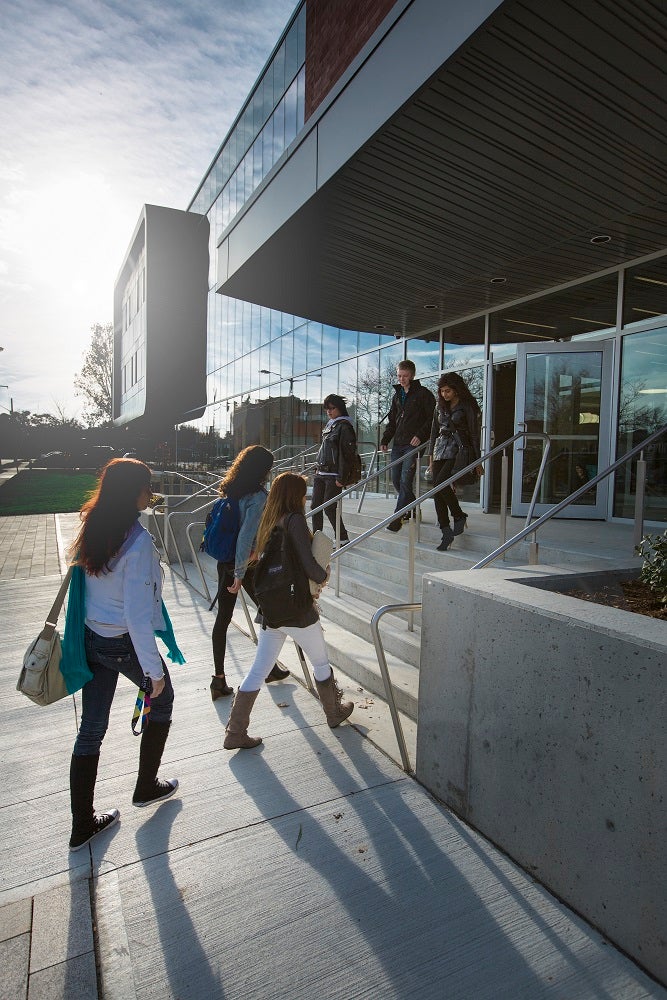 students walking up the front steps of the Stratfor Campus