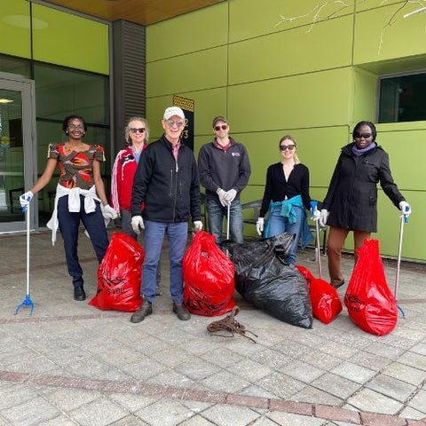 Employees outside of EV3 with garbage bags