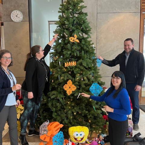Green Office employees from Pharmacy decorating Christmas tree