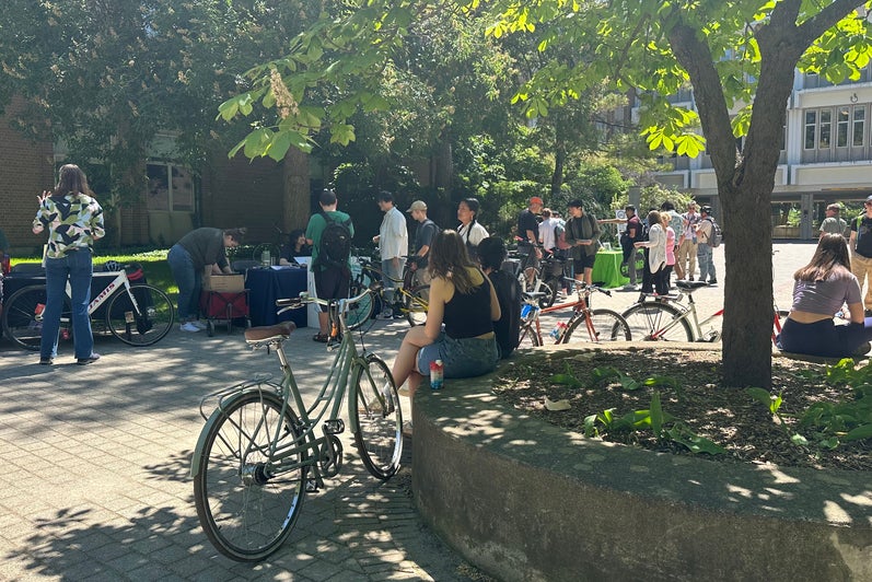 people with bikes on campus sitting on ledge