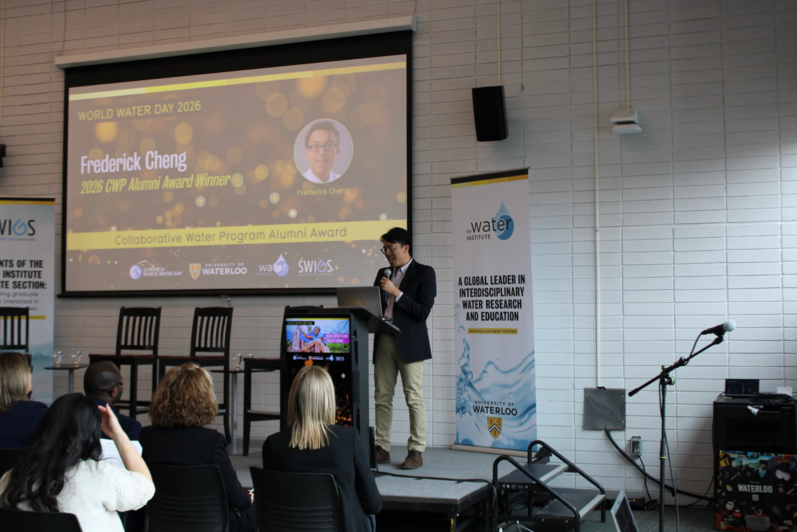 Alumini Frederick Cheng presenting at the podium 