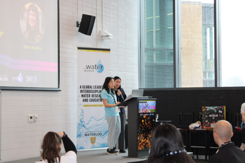 Two presenters standing at the podium