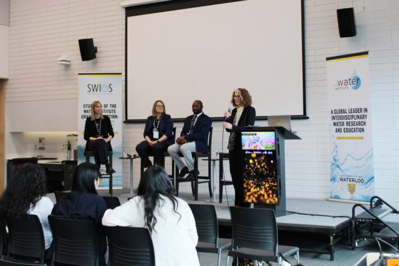 Pane with four panelists sitting on stage 