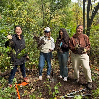 group photo of four people holding buckthorn roots