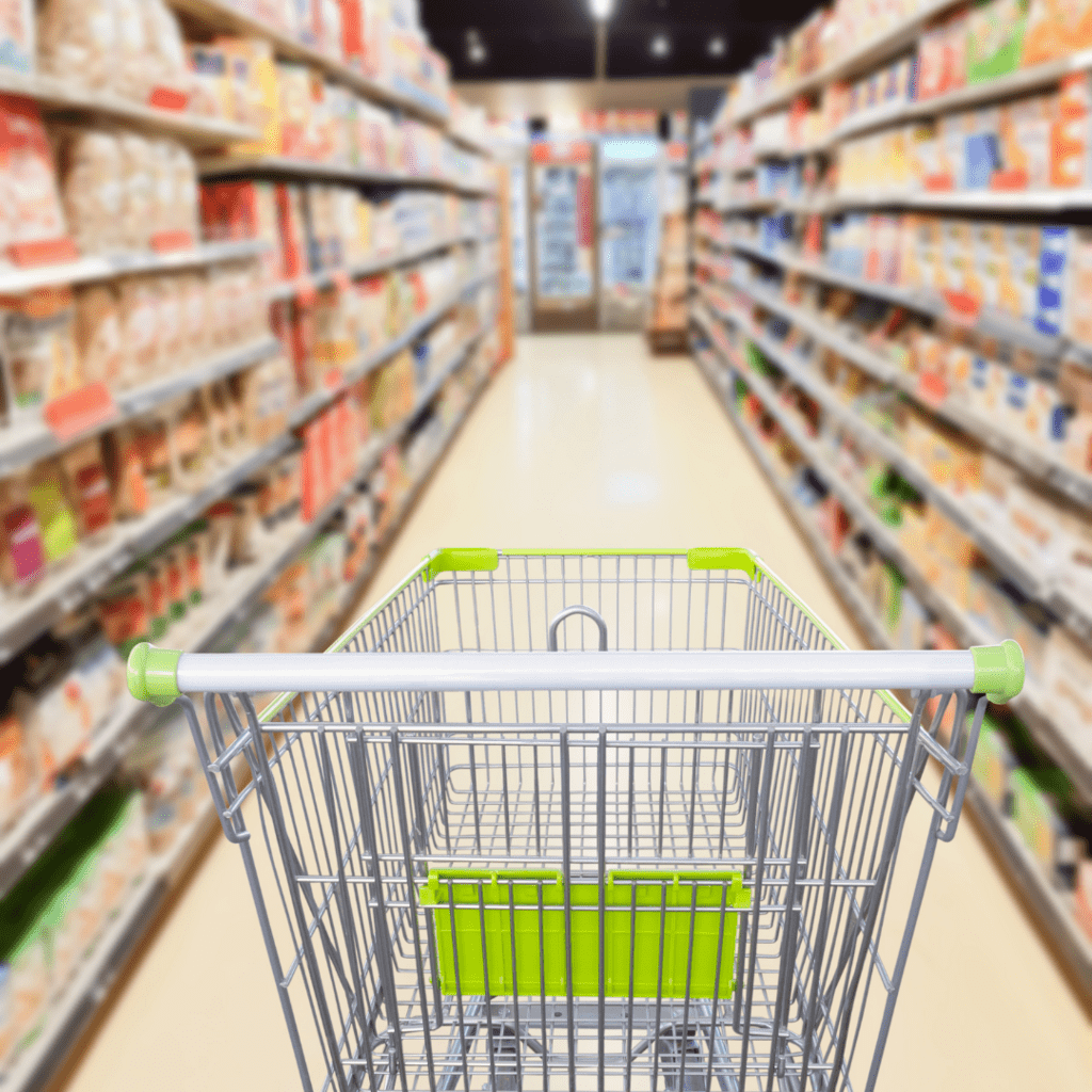 Grocery cart leading down a shopping aisle