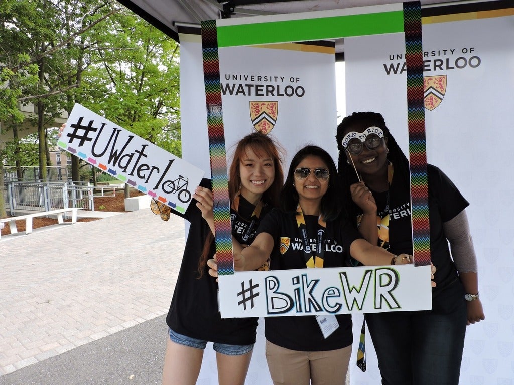 Sustainability Office volunteers posing with a polaroid frame with hashtag Bike WR and UWaterloo