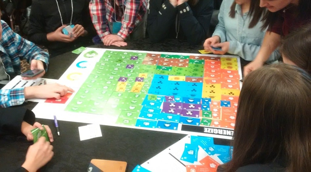 Students playing the Energize: Sustainable City Challenge board game