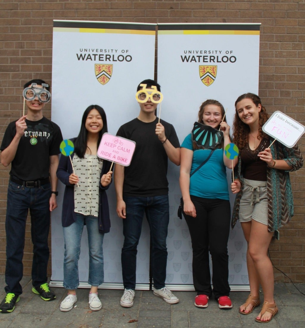 5 students in front of a photobooth with props at Bike Lunch