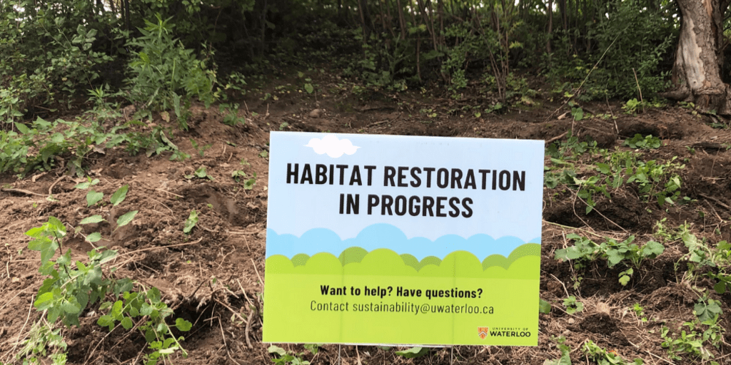 A sign that says habitat restoration in progress